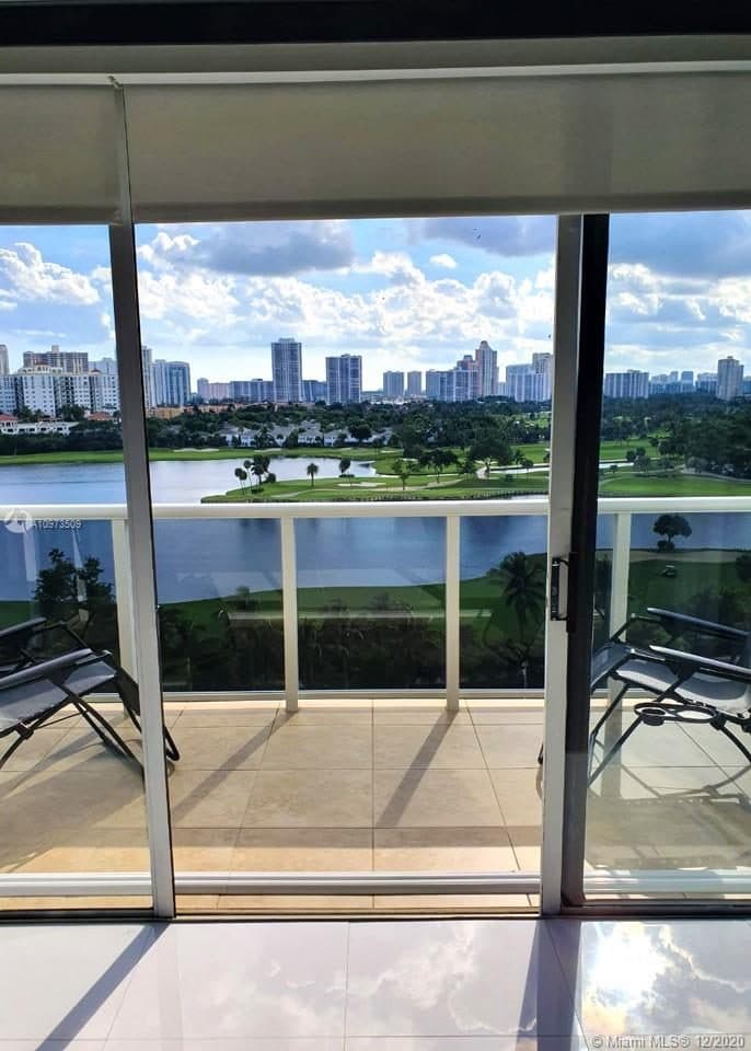 A glass balcony railing looking over the golf course and a lake